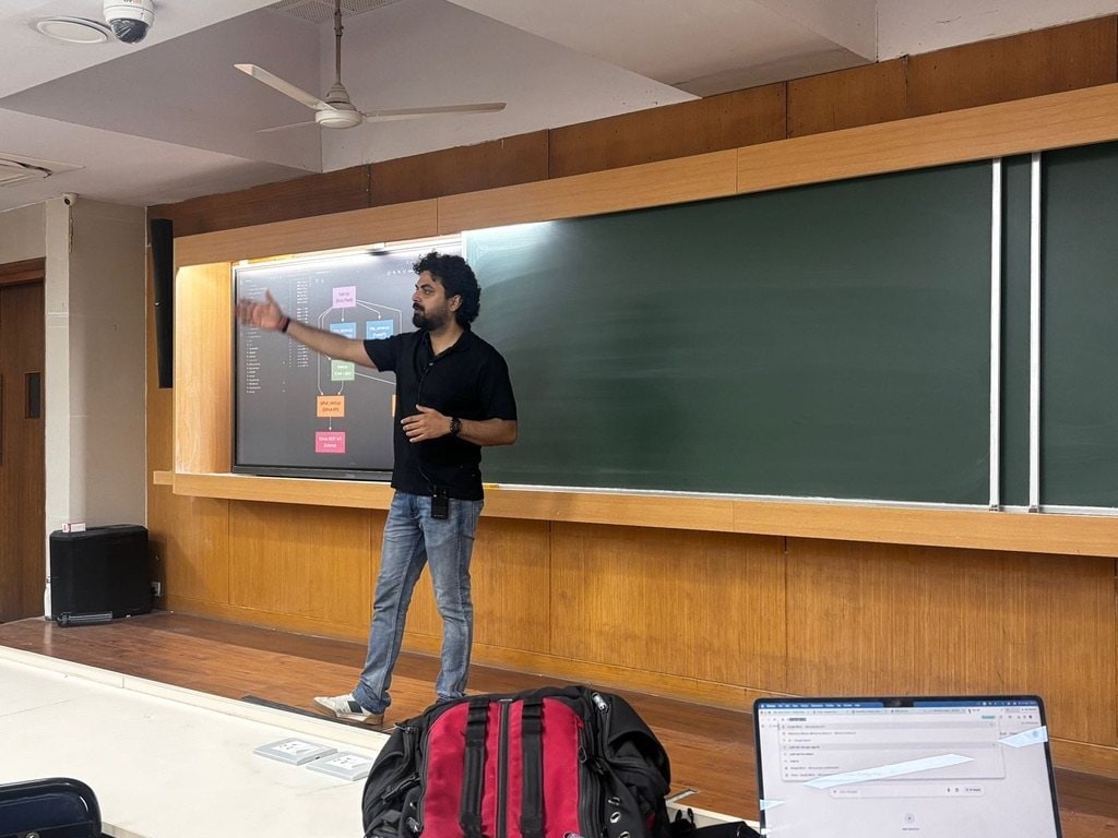 Ashish Tripathi teaching at a board in an IIT Bombay lecture hall